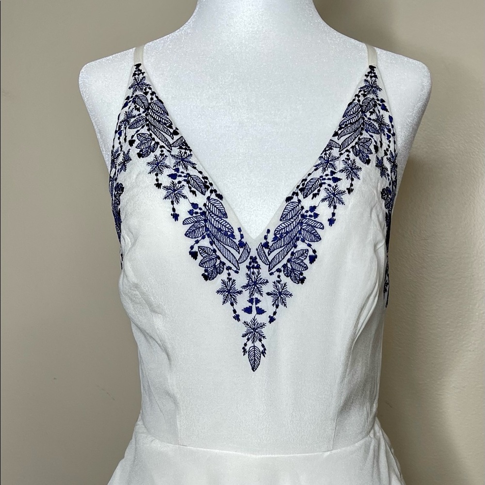 Bebe short white jumpsuit with blue flowers
